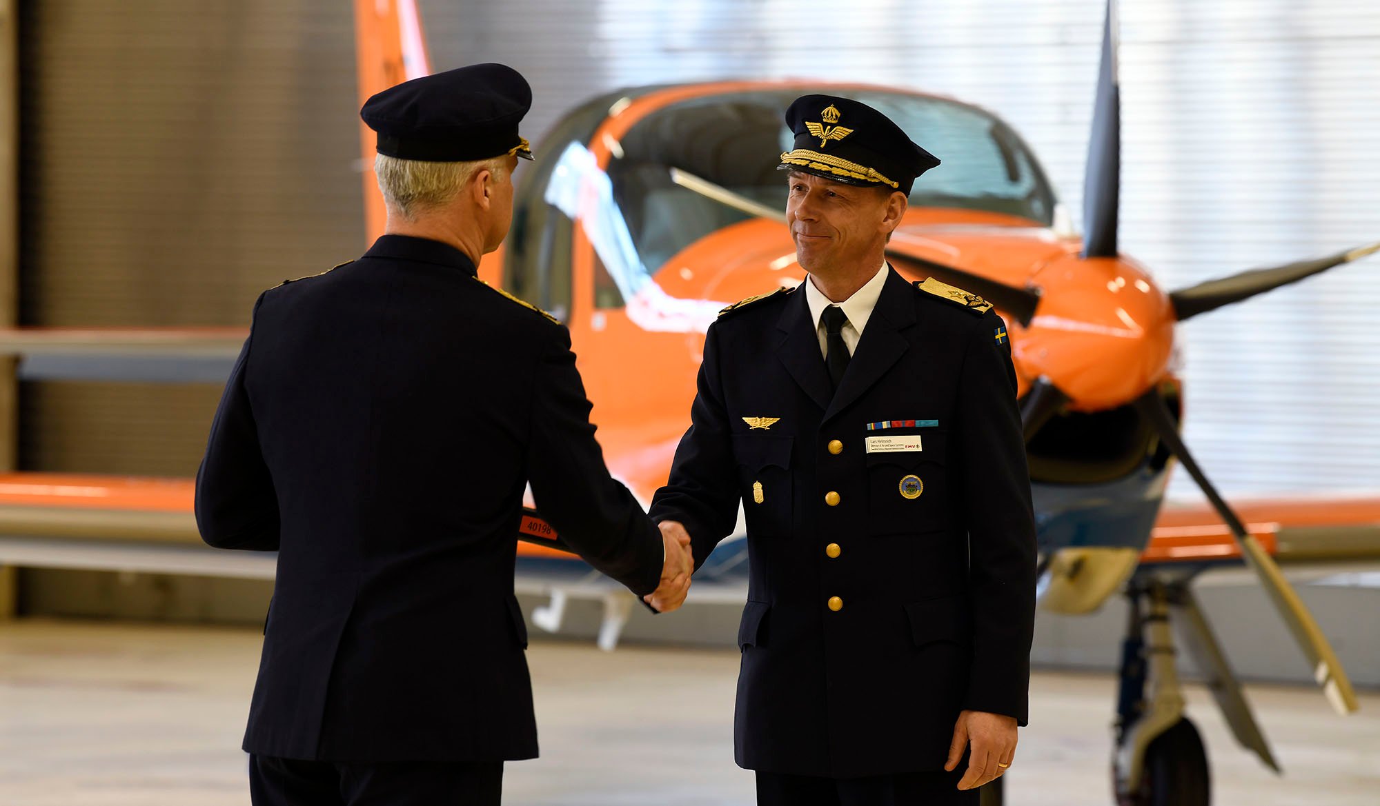 Lars Helmrich, chef för FMV:s verksamhetsområde Flyg- och rymdmateriel, överlämnar Försvarsmaktens nya skolflygplan till Jonas Wikman, flygvapenchef. 
