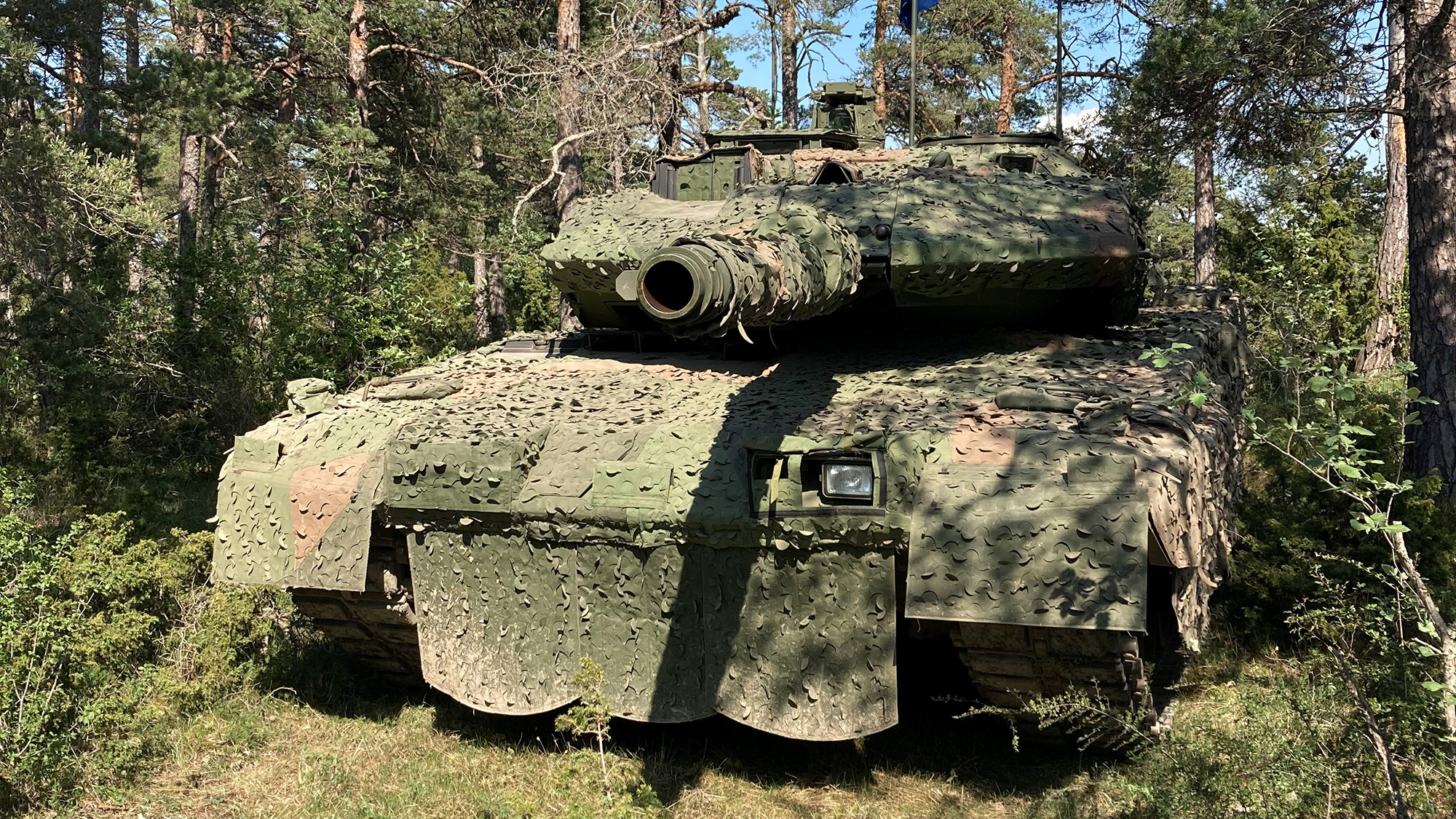 En stridsvagn täckt med ett maskeringsnät.